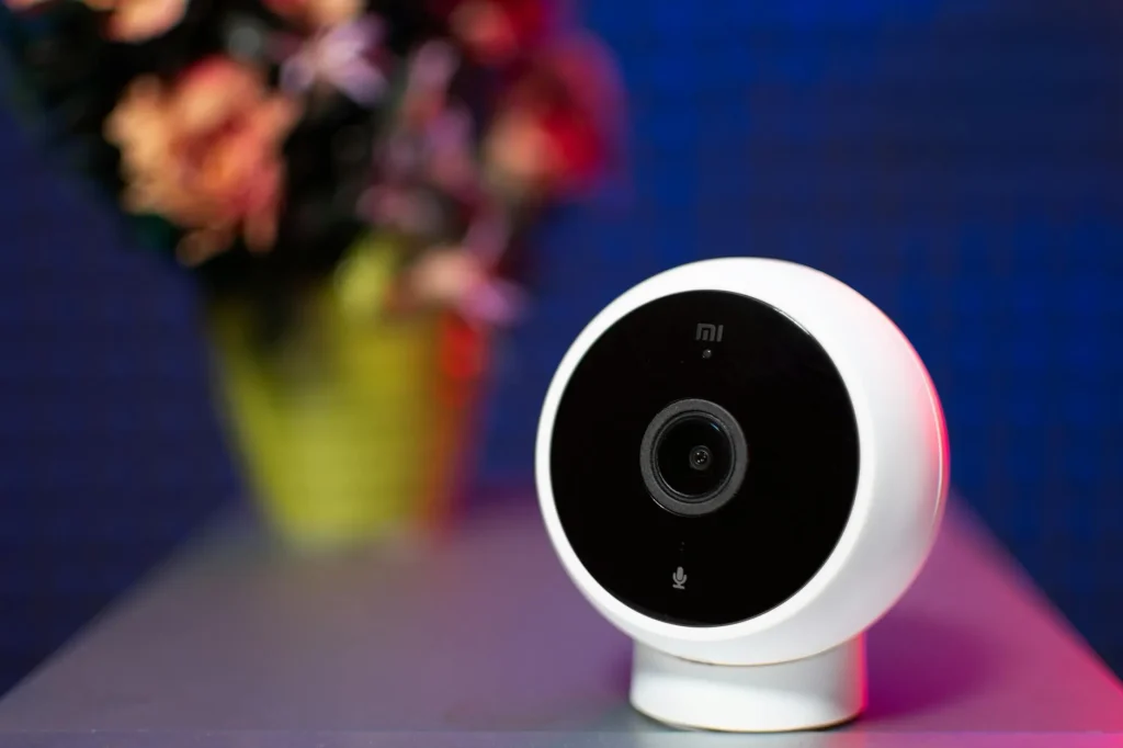 White indoor smart security camera on a clean modern surface