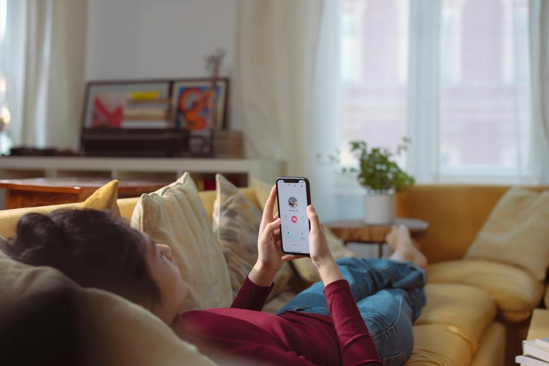 Person using smartphone in a home living room setting
