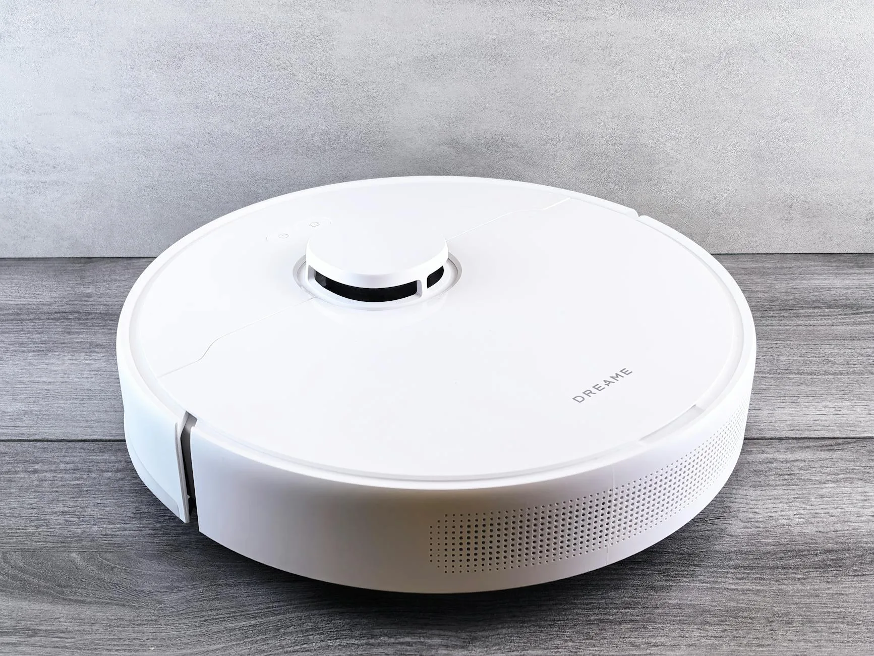 Robot vacuum navigating across a floor in a modern home