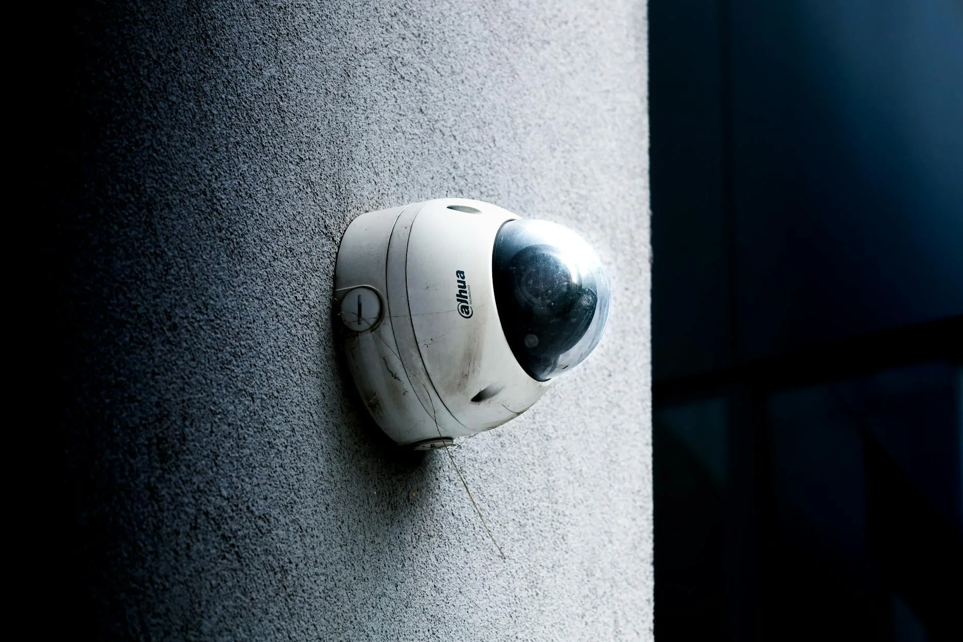 Dome security camera mounted on an exterior wall