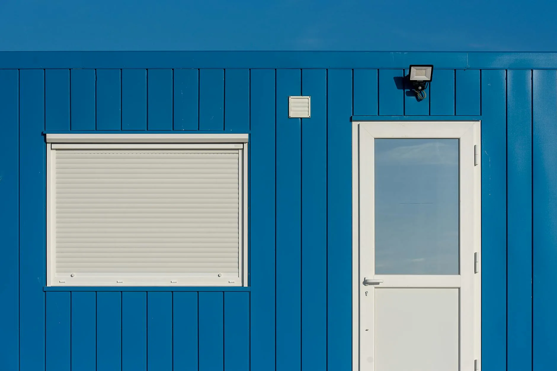 Smart door and window sensors installed on a white door frame