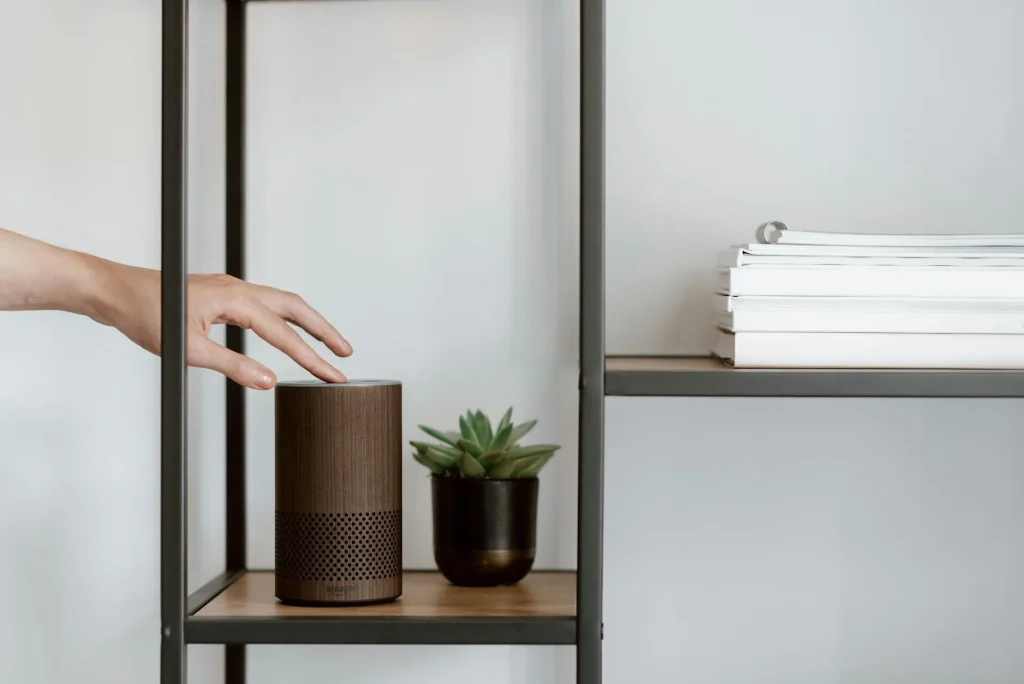 Smart home devices including speaker and tablet on a living room shelf
