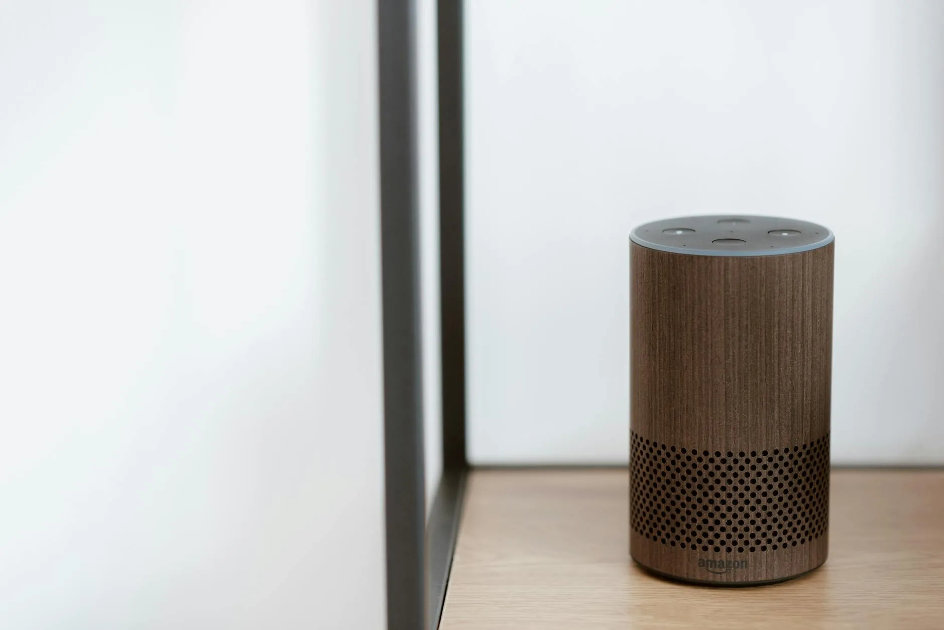 Smart voice assistant speaker on a modern shelf at home