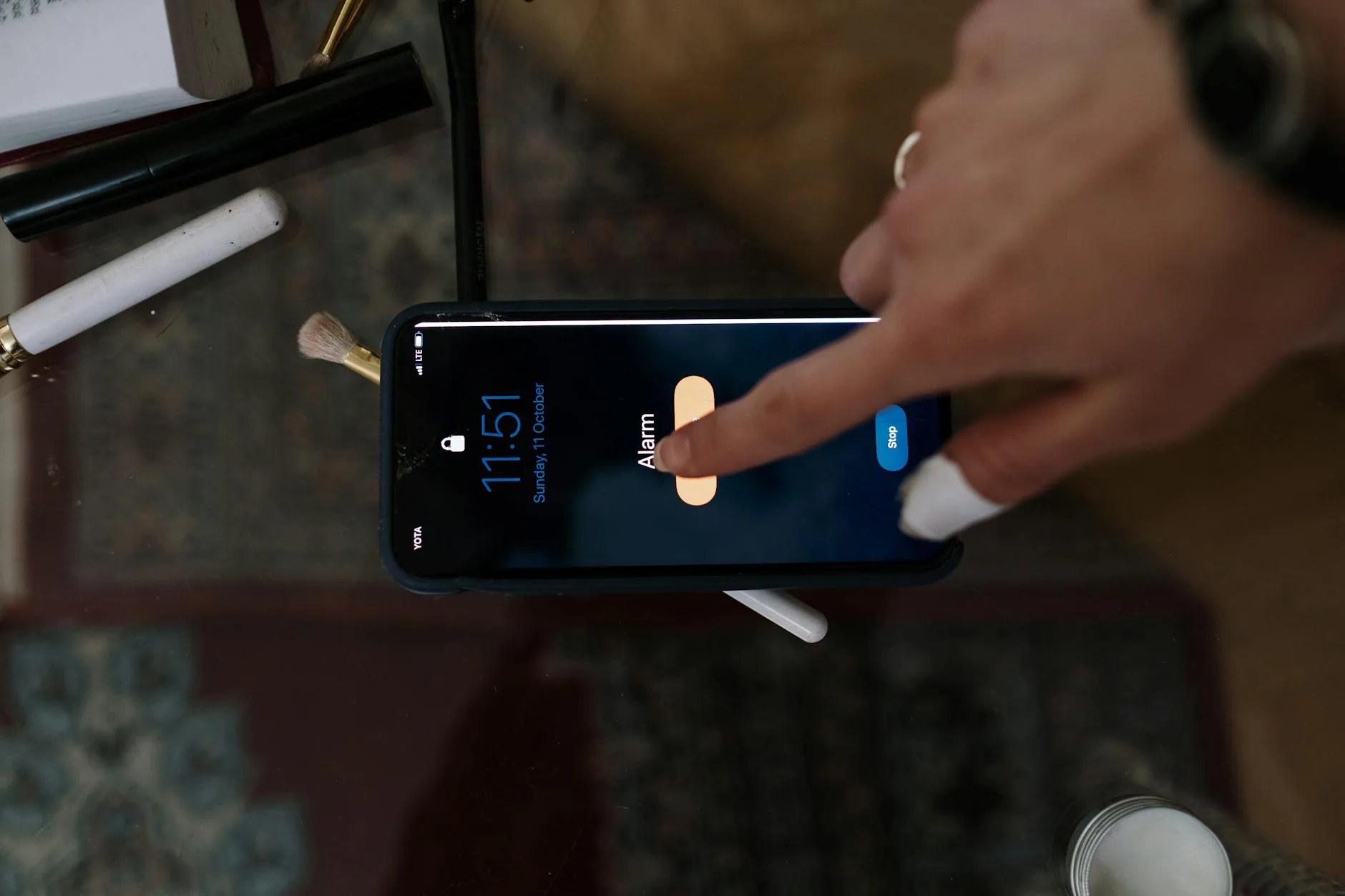 Person checking a home security app notification on a smartphone