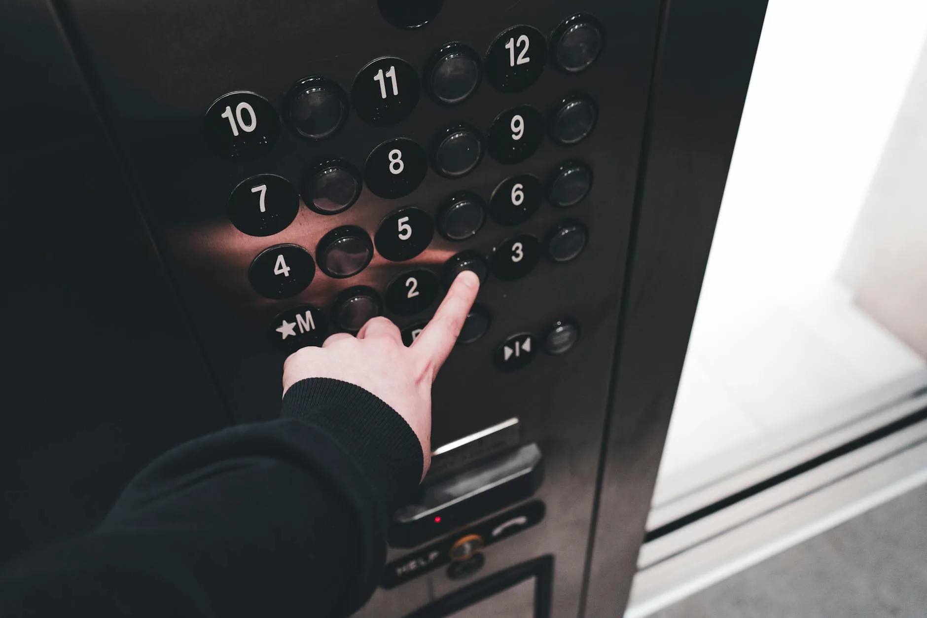 Finger pressing buttons on a digital control panel