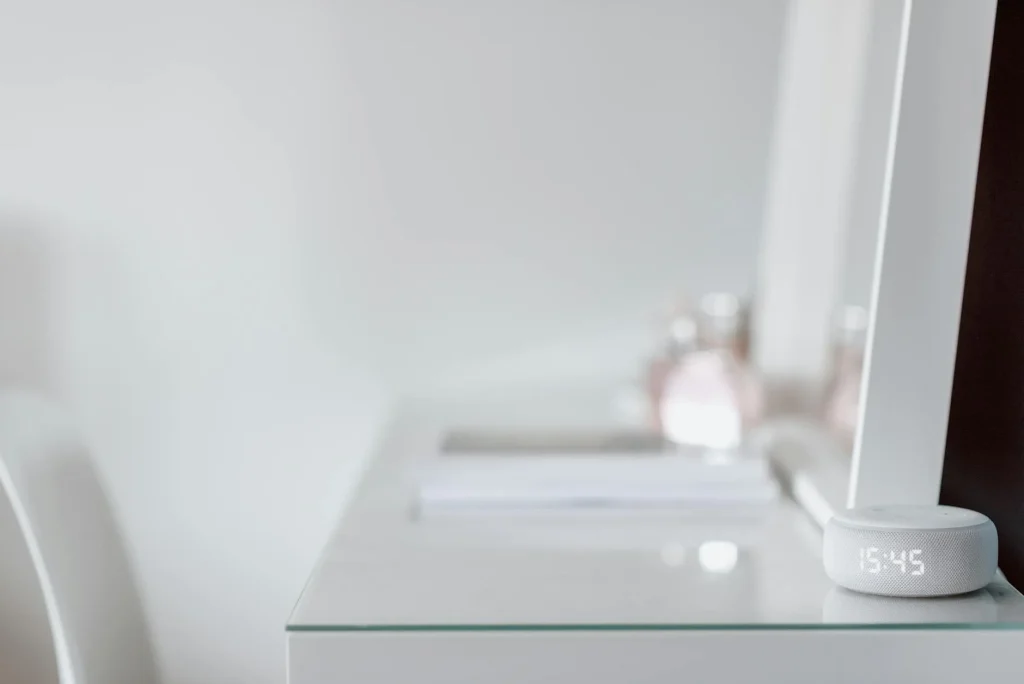 Smart speaker on a kitchen counter next to a coffee mug