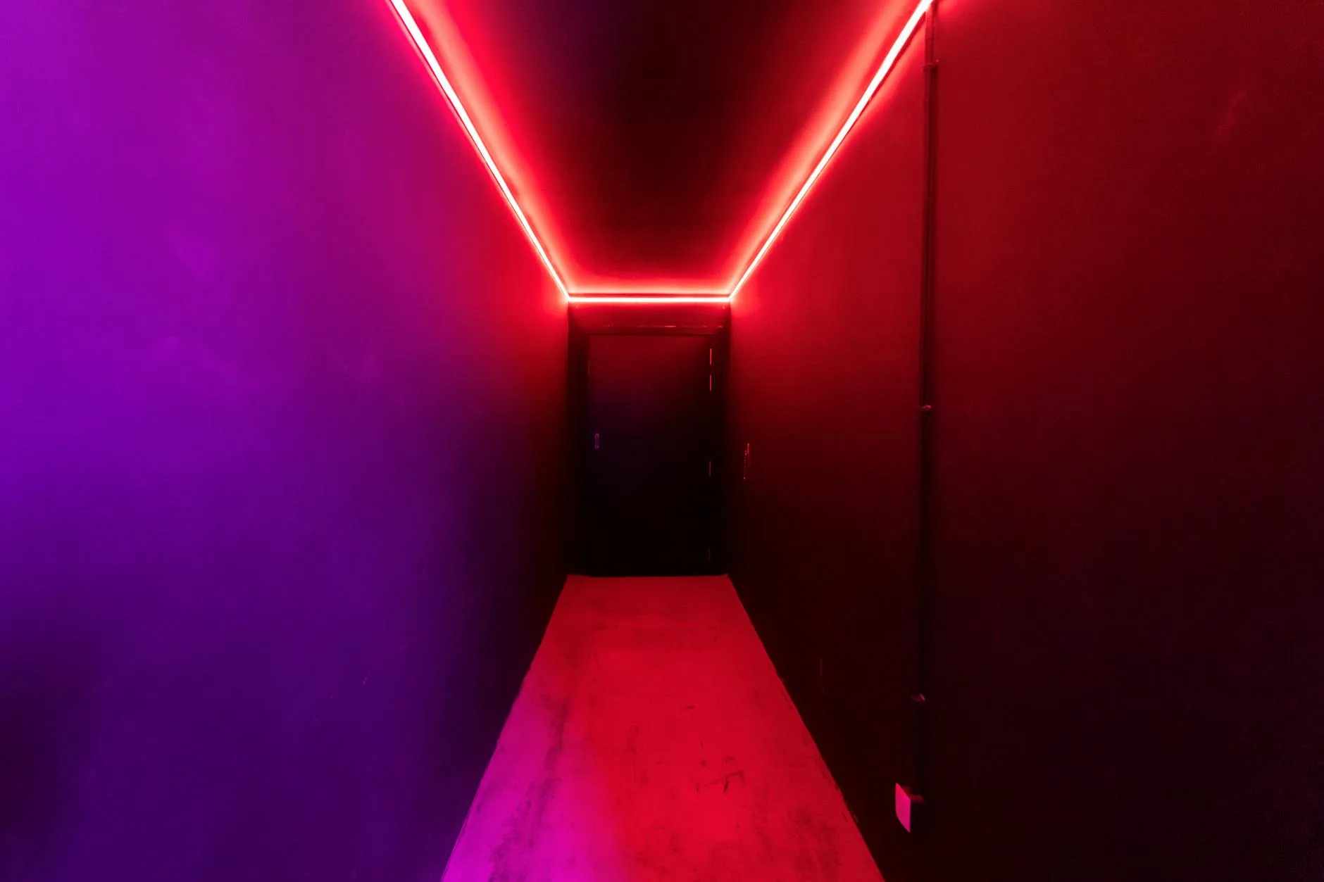 LED light strip glowing purple and blue in a modern room setup