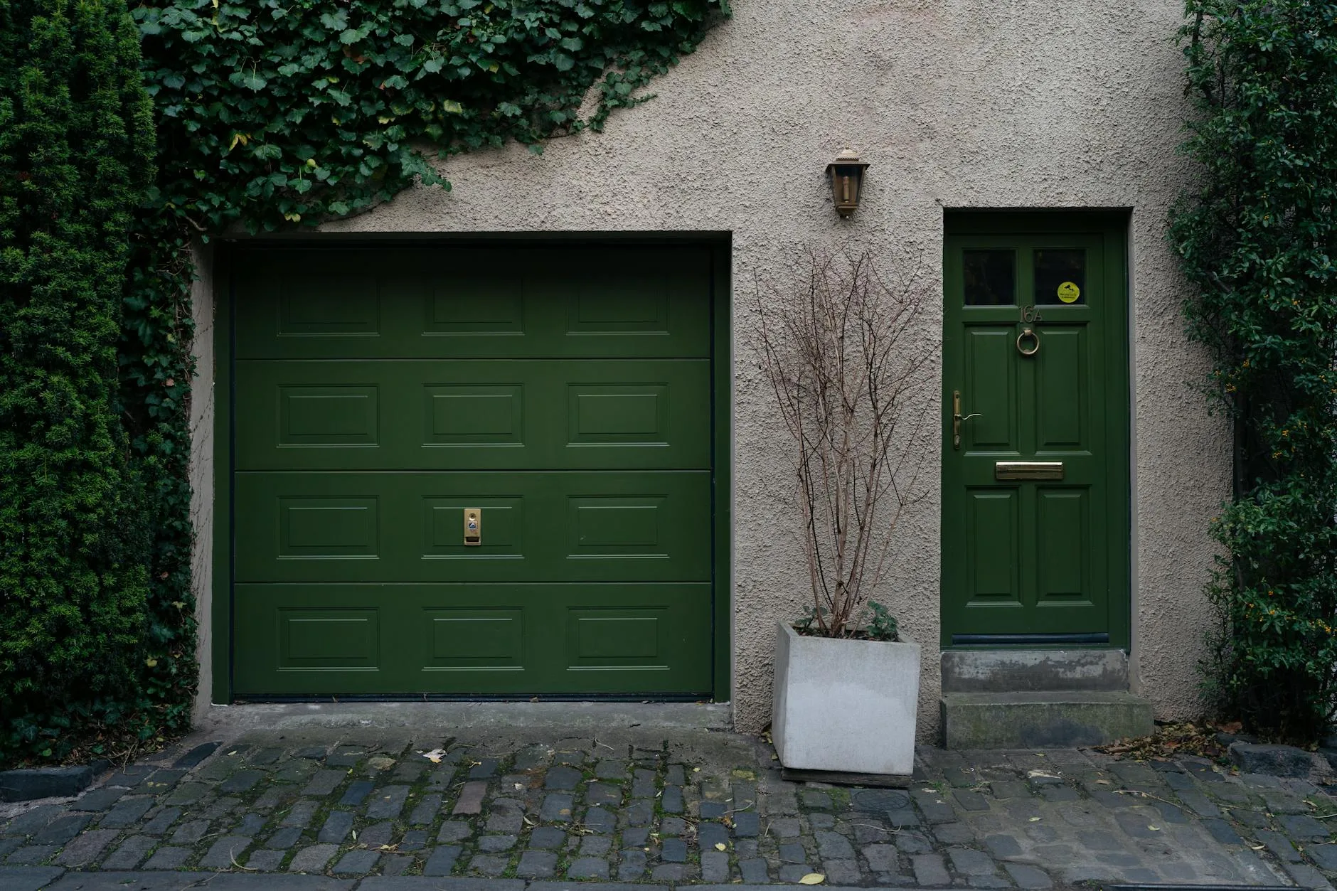 Installer setting up a smart opener on a British up-and-over garage door