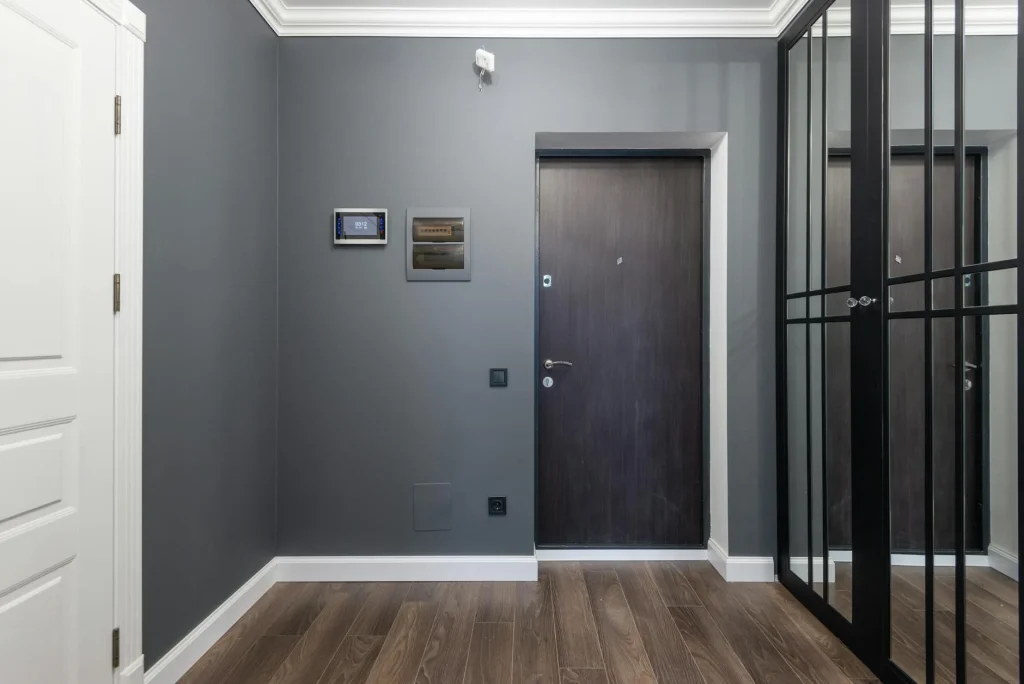 Smart alarm keypad near a front door in a home hallway